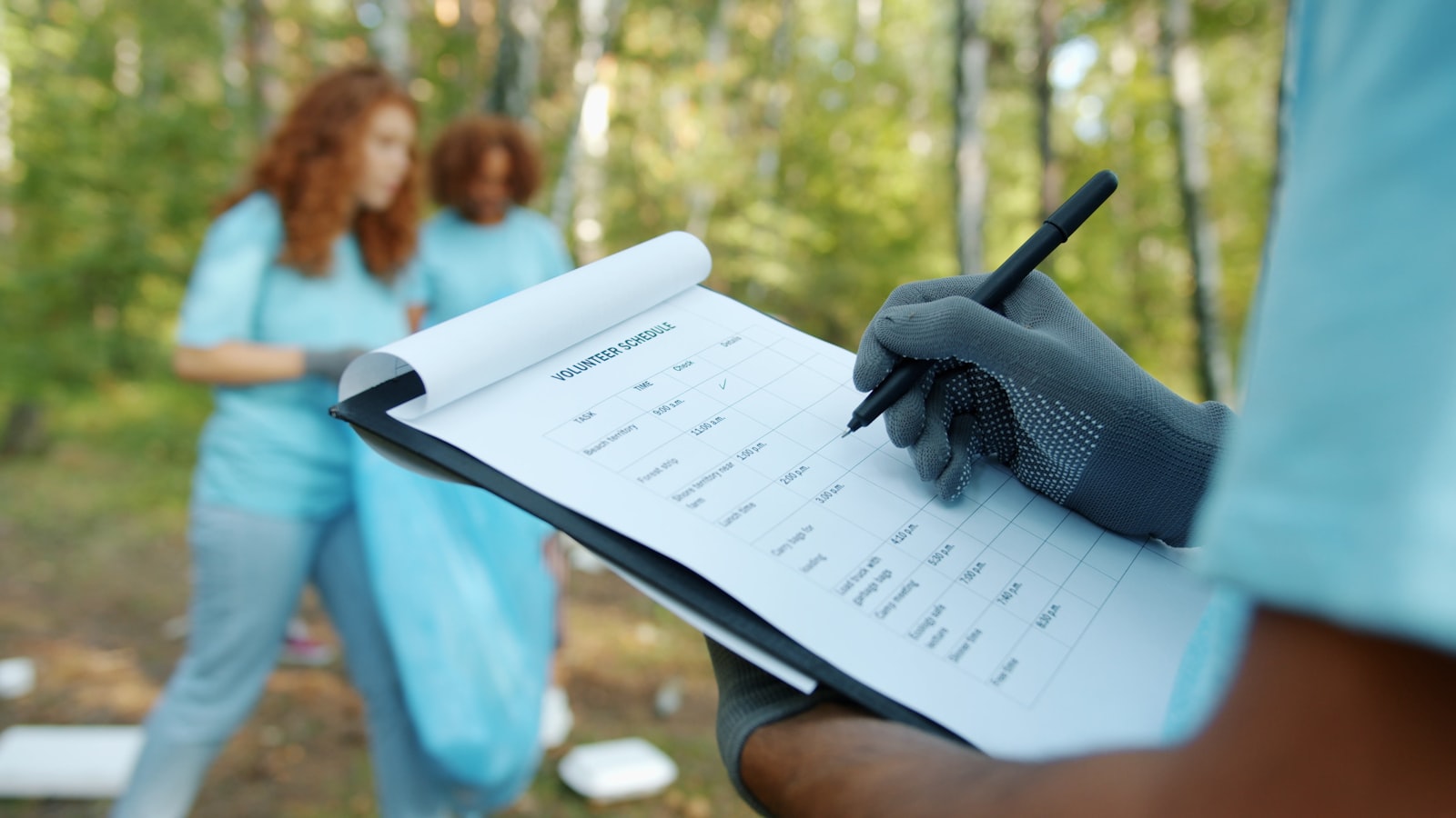 Volunteers reviewing a clipboard checklist while coordinating a community event
